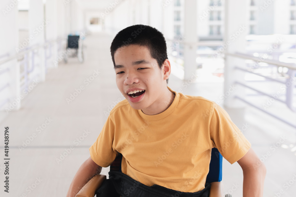 Asian special child on wheelchair is smiling face as happiness on ramp for disabled people background in hospital, Lifestyle in the education age of disabled children, Happy disability kid concept. Asian special child on wheelchair is smiling face as happiness on ramp for disabled people background in hospital, Lifestyle in the education age of disabled children, Happy disability kid concept.