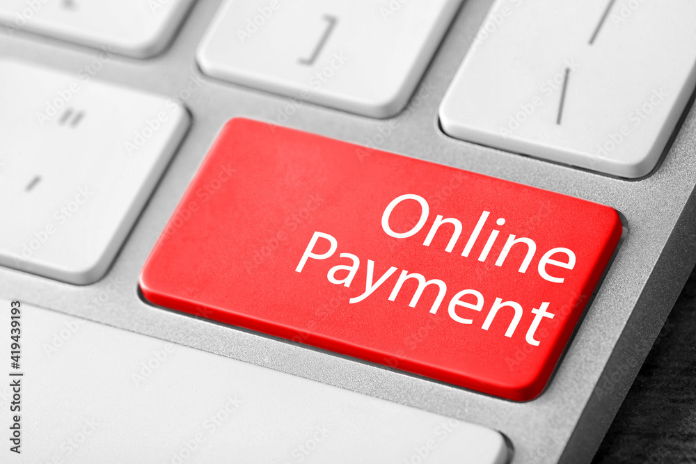 Fototapeta premium Modern laptop keyboard with text Online Payment on red button, closeup view