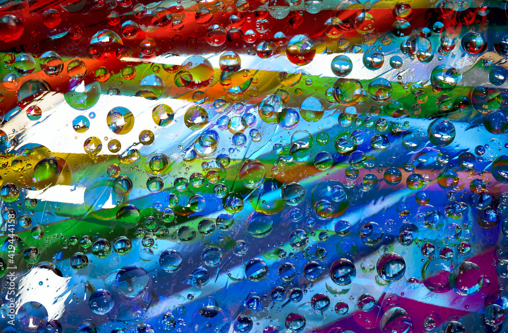 Tracery. Variegated spheres of different diameters are located on a rainbow background. Abstract fantasy. 3D render