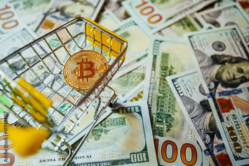 Bitcoin vs Dollars Shopping Cart Background of Hundreds of Dollars Green Yellow