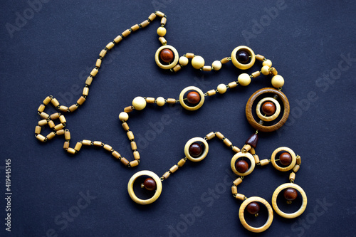 Wooden beautiful round beads on black background