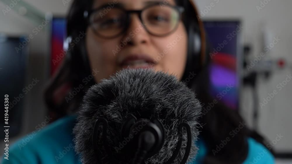The microphone is in focus and the girl is blurred in the background The microphone is in focus and the girl is blurred in the background
