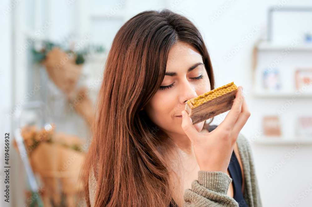 Female client enjoying fragrant smell of aromatic homemade soap made of natural ingredients in eco store Female client enjoying fragrant smell of aromatic homemade soap made of natural ingredients in eco store