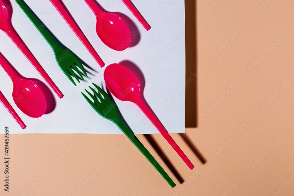 Overhead view of colorful eco friendly cutlery on pastel background Overhead view of colorful eco friendly cutlery on pastel background