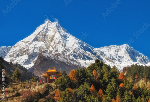 Beautiful peak Manaslu in the autumn Himalaya mountains in Nepal with a Buddhist monastery at the foot photo