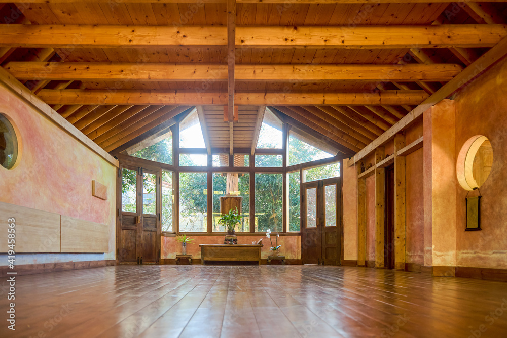 Interior of spacious meditation hall in house with potted plants and ...