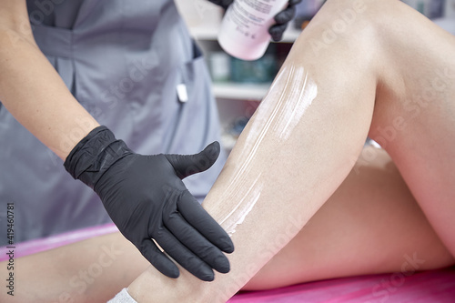 Sugaring procedure. Beautiful smooth legs close up. Hot wax, health care, beauty industry, hair removal. 