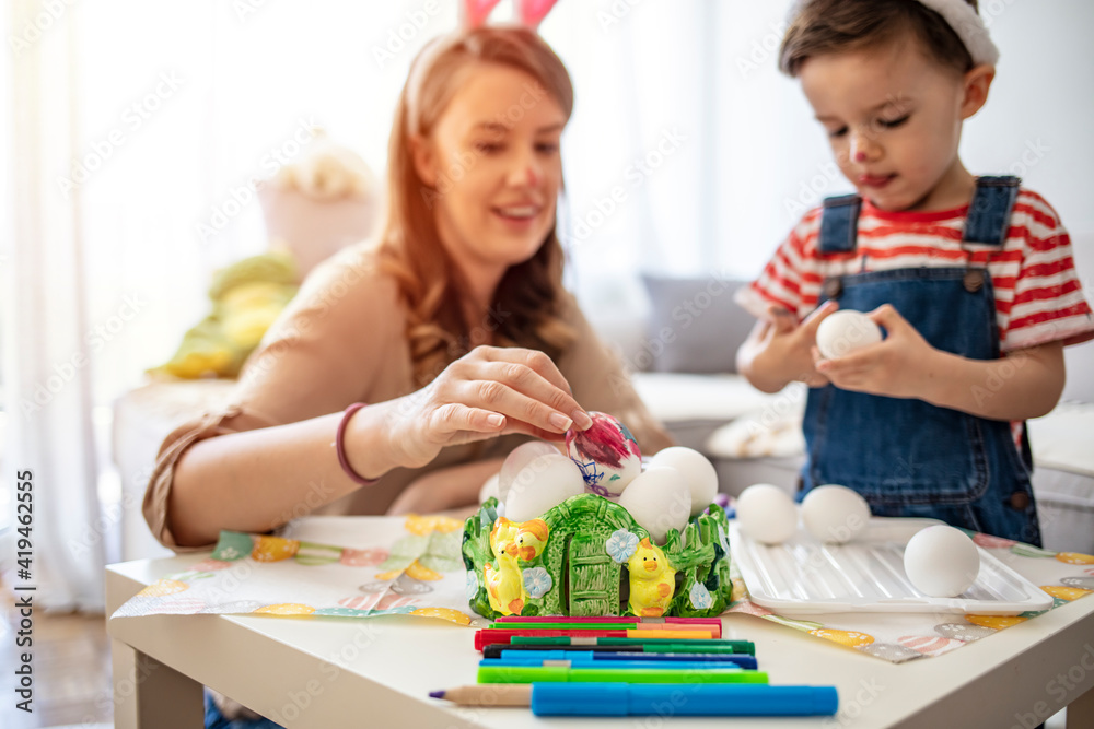 Mother and her son preparing for Easter, painting Easter eggs. Mother And Son Enjoying Creative Easter Morning, Coloring Eggs. Coloring Eggs For Easter Mother and her son preparing for Easter, painting Easter eggs. Mother And Son Enjoying Creative Easter Morning, Coloring Eggs. Coloring Eggs For Easter