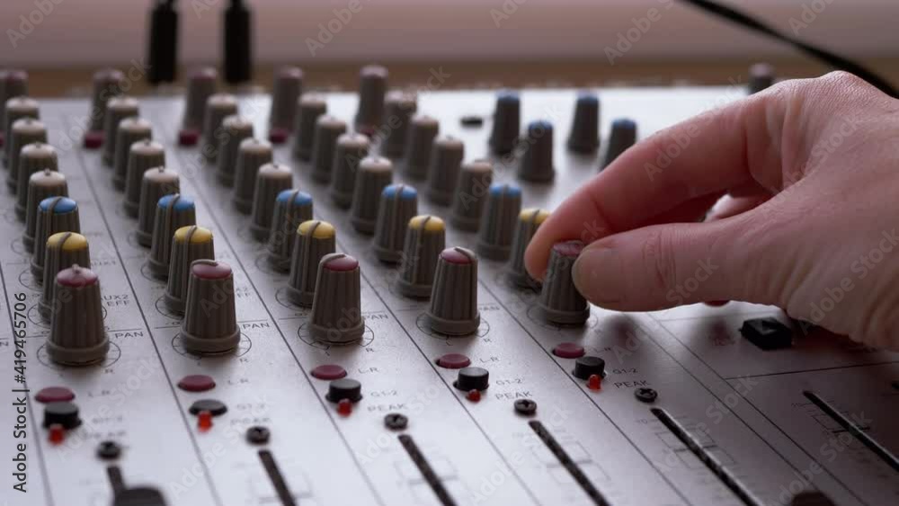 Sound Engineer, DJ Moves Sliders with Fingers on Audio Mixer in Recording Studio Sound Engineer, DJ Moves Sliders with Fingers on Audio Mixer in Recording Studio