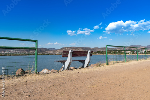 Bench overlooking the lake of the León Guanajuato metropolitan park. Relaxation concept.