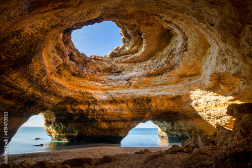 Scenic view of Benagil Cave with holes on shore against endless ocean in Algarve Portugal