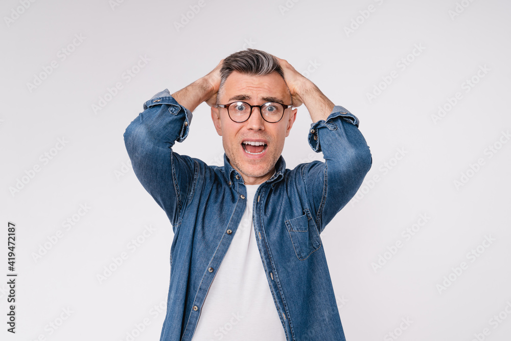 Scared handsome man is crying and shocked isolated over white background Scared handsome man is crying and shocked isolated over white background