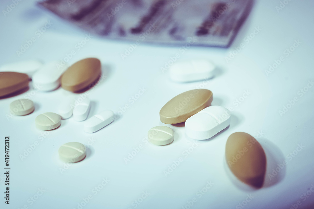Pharmaceutical medicine pills in both tablets and capsules with the vintage retro picture style. Pharmacy theme and treatment medication as concept. Pharmaceutical medicine pills in both tablets and capsules with the vintage retro picture style. Pharmacy theme and treatment medication as concept.
