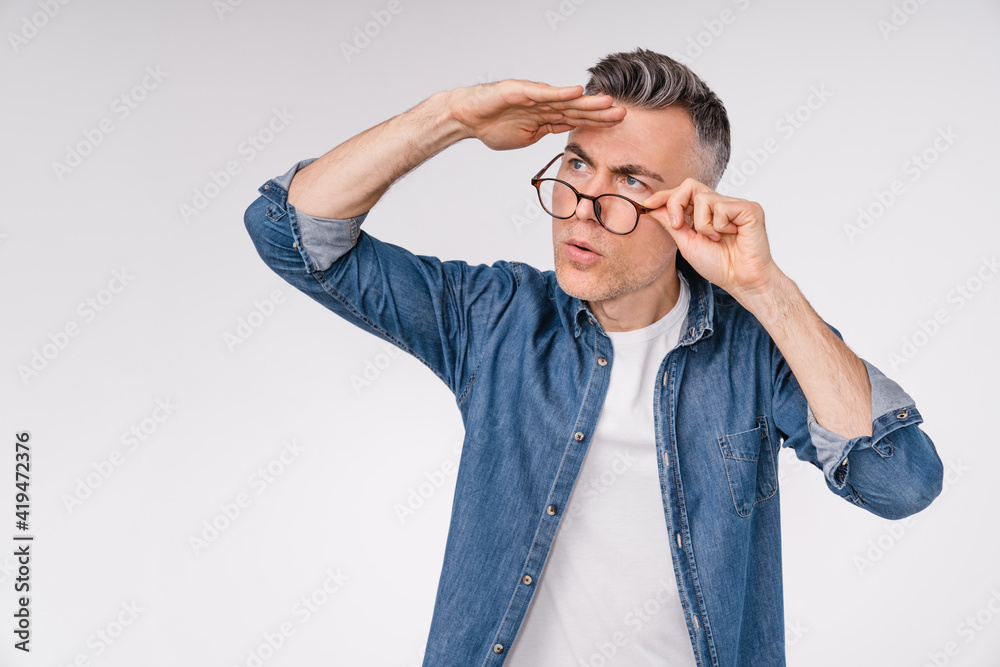 Handsome caucasian man looking far away isolated over white background Handsome caucasian man looking far away isolated over white background