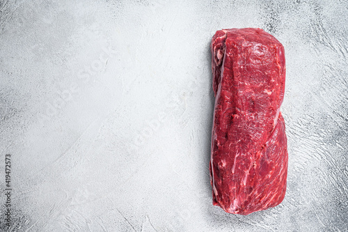 Raw Whole Tenderloin beef meat. White background. Top view. Copy space