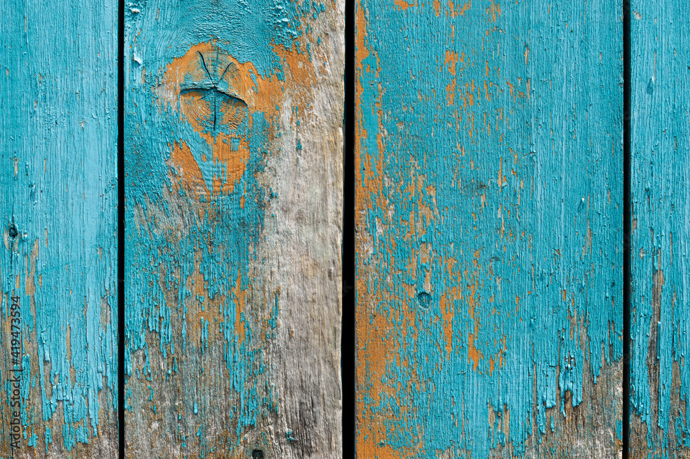 Old wall of wooden planks with paint cracked .