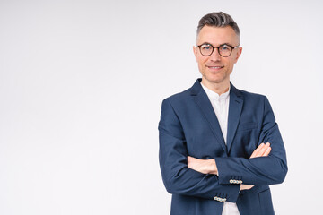 Good-looking middle-aged businessman with arms crossed isolated in white background