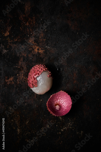 Top view of lychee on dark rustic wooden background