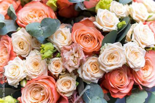 Wedding bouquet of orange and white roses  lisianthus and eucalyptus