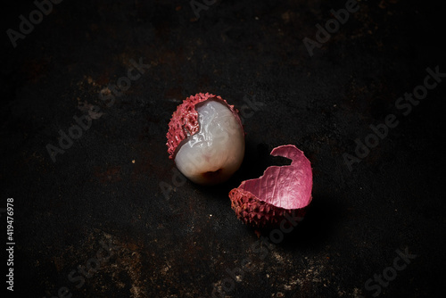 Top view of lychee on dark rustic wooden background photo