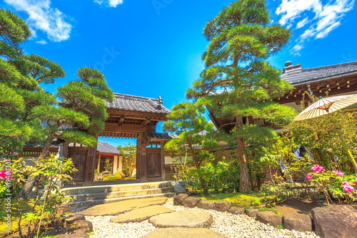 Kamakura, Japan - April 23, 2017: entrance at traditional zen garden in a sunny day inside Hase-Dera Shinto. Hasedera Temple is a popular landmark in Kamakura. Concept of meditation and peace. photo