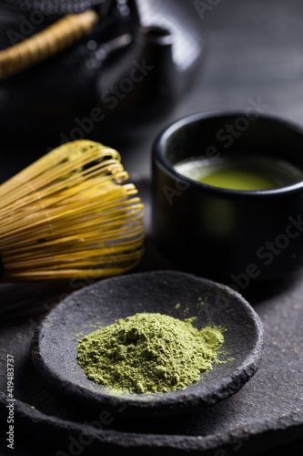 From above of traditional Japanese matcha with tea whisk in stone bowl for traditional oriental ceremony photo