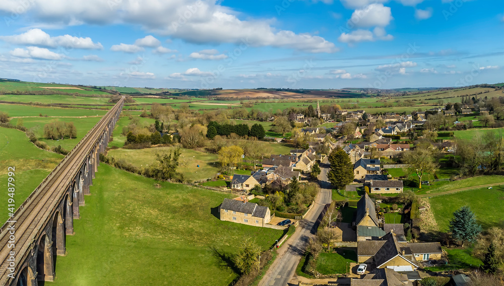 Naklejka premium An aerial view the village of Harringworth and its railway viaduct on a sunny day in the UK