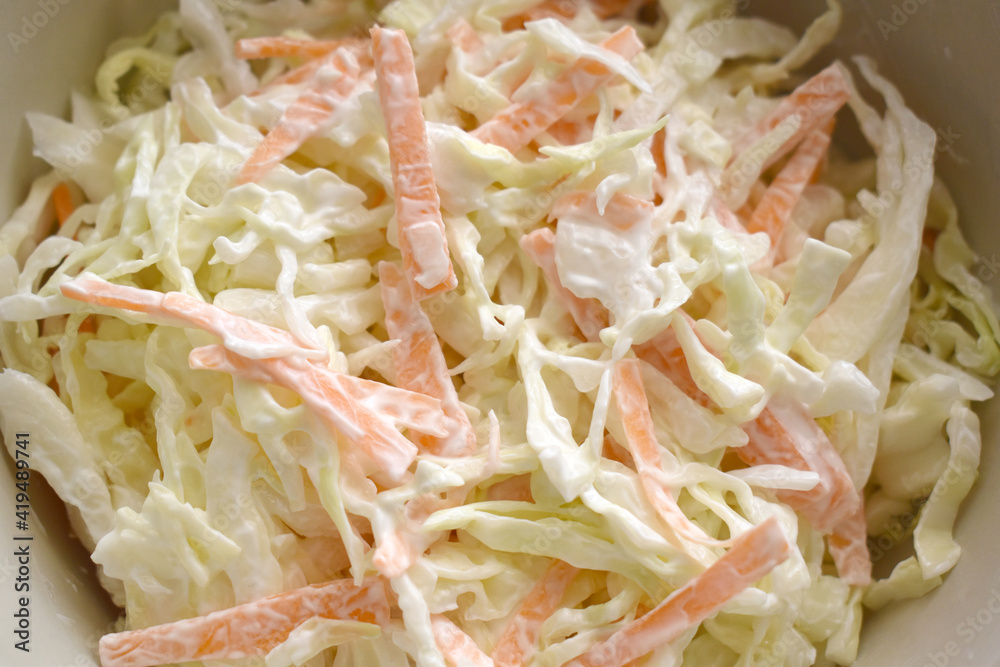 Coleslaw with cabbage and carrot in a bowl. Healthy and dietary food concept. Coleslaw with cabbage and carrot in a bowl. Healthy and dietary food concept.