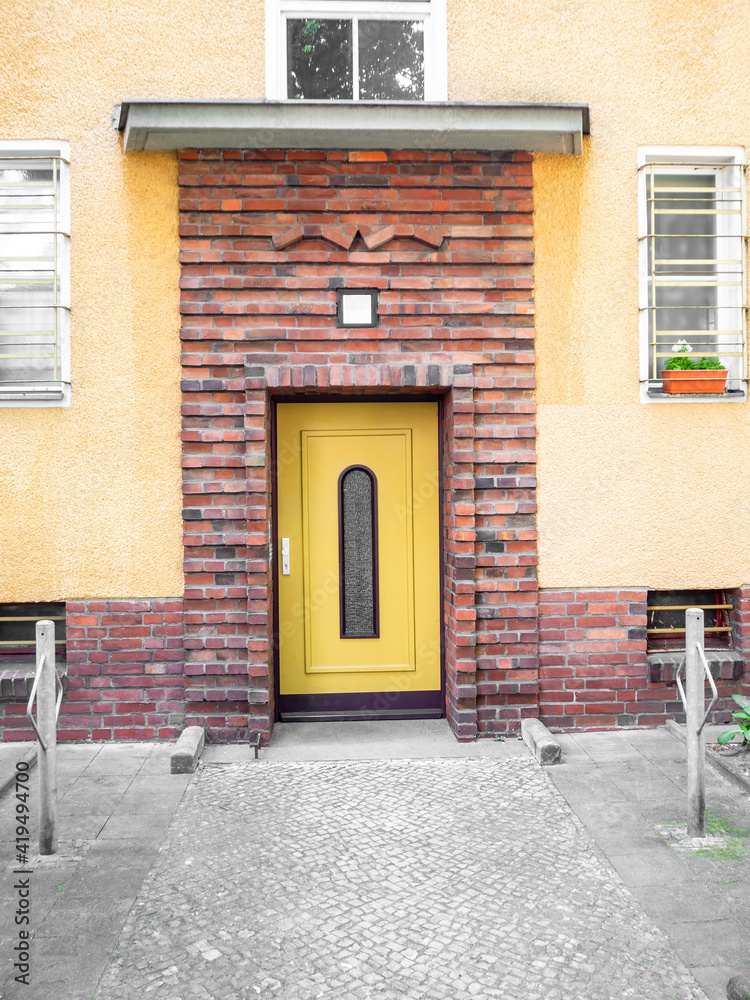 Yellow wooden entrance door with glass insert