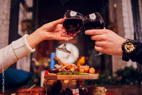 Clinking glasses with alcohol and toasting, party.