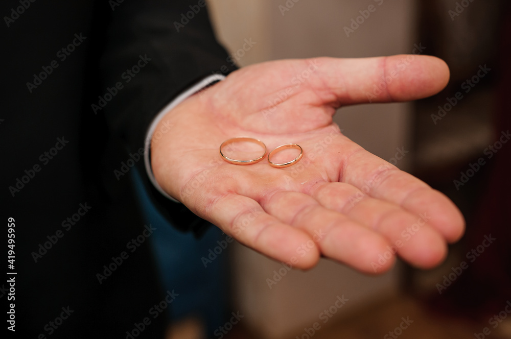 Wedding gold rings in the hands of the groom Wedding gold rings in the hands of the groom