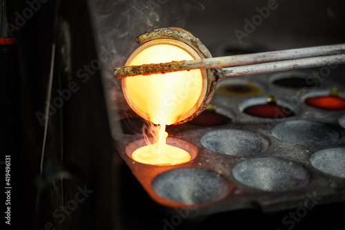 Melted rock, metal in a ceramic cup and poured into a form