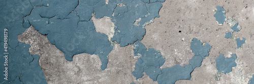 Peeling paint on the wall. Panorama of a concrete wall with old cracked flaking paint. Weathered rough painted surface with patterns of cracks and peeling. Grunge texture for wide panoramic background © Andrei Stepanov