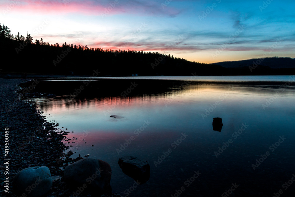 Fototapeta premium dramatic, peaceful and serene summer sunset photo of Lake McDonald in Glacier National Park in. Montana.