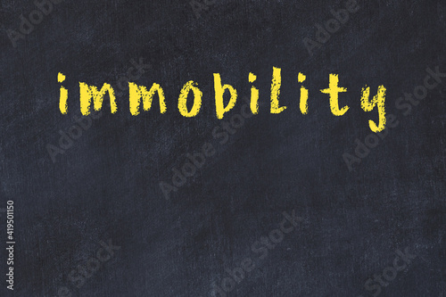 Black chalkboard with inscription immobility on in