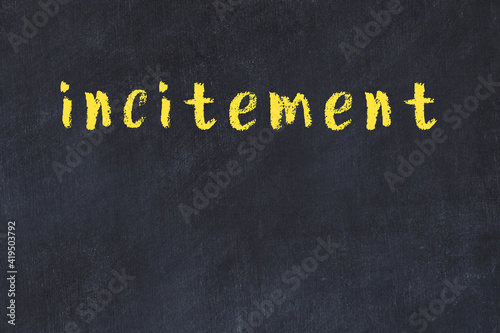 Black chalkboard with inscription incitement on in