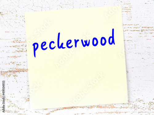 Yellow sheet of paper with word peckerwood. Reminder concept photo