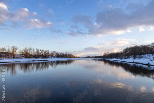 River in early spring. The clouds are reflected in the river. © Sergei