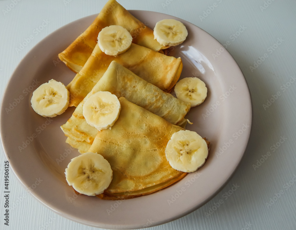 pancakes on a plate with banana slices