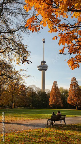 Autumn Park Rotterdam Euromast people sitting on a bench - The Netherlands photo