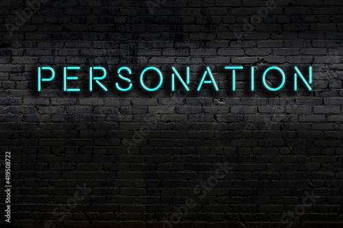 Photos Night view of neon sign on brick wall with inscription personation