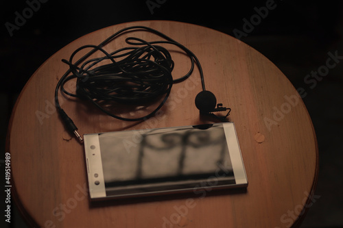 Cell phone with lapel microphone to record audio. photo