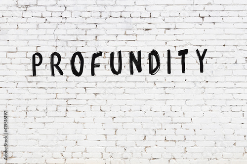 White wall with black paint inscription profundity on it