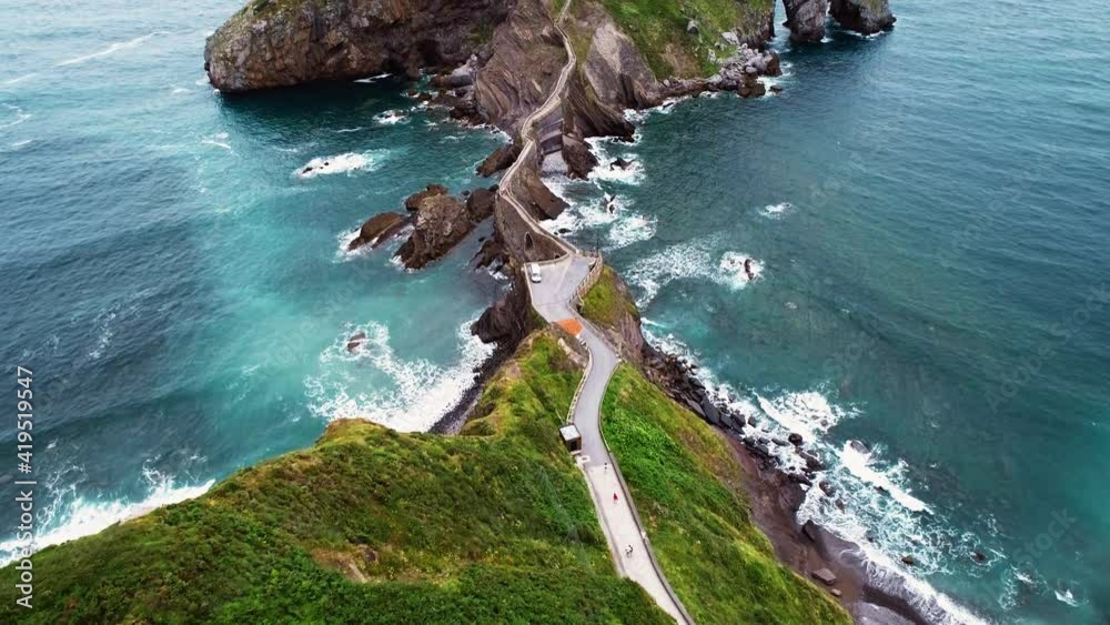 Magnificent aerial opening shot of the Gaztelugatxe islet in Spain.