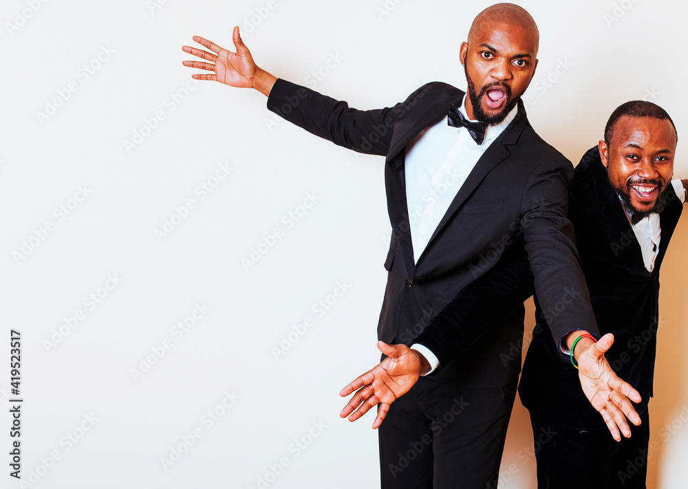 two afro-american businessmen in black suits emotional posing, gesturing, smiling. wearing bow-ties two afro-american businessmen in black suits emotional posing, gesturing, smiling. wearing bow-ties