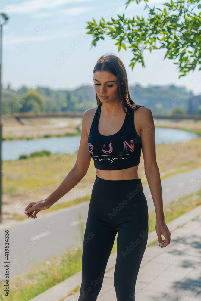 Healthy young woman learning to ride on roller skates and how to keep balance Healthy young woman learning to ride on roller skates and how to keep balance