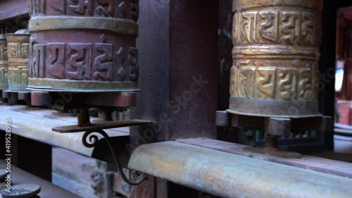 Some Buddhist prayer wheels at a temple in Patan Durbar Marg in Nepal. photo