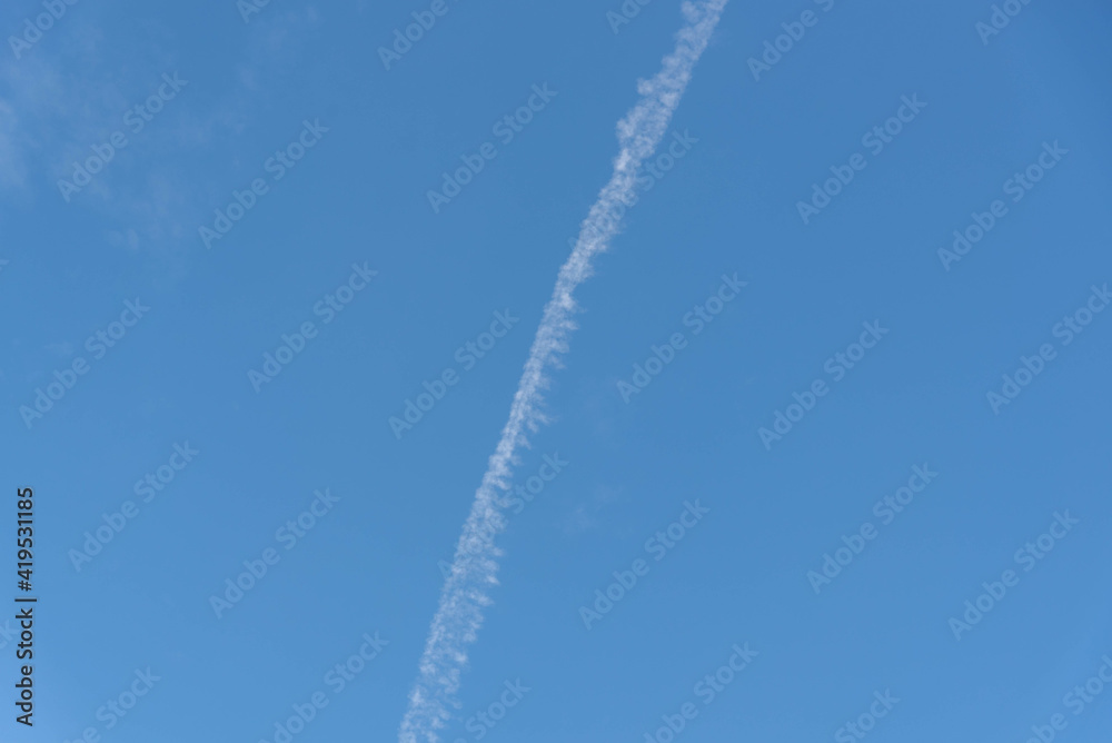 Blue sky cut by smoke from airplane fuel Blue sky cut by smoke from airplane fuel