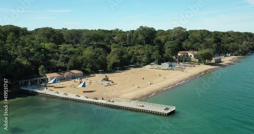 Aerial of a beautiful suburban beach with pier and big sandy area photo