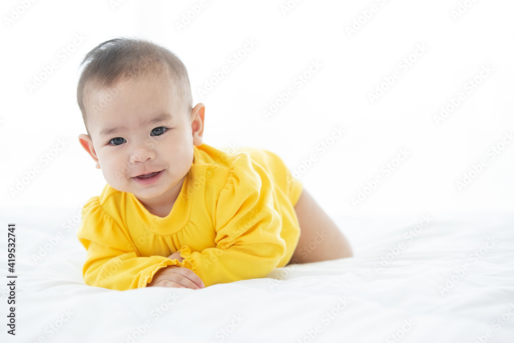 Portrait and focus to eye adorable baby child on white bed in bedroom look at camera with bright soft light in morning in background Portrait and focus to eye adorable baby child on white bed in bedroom look at camera with bright soft light in morning in background